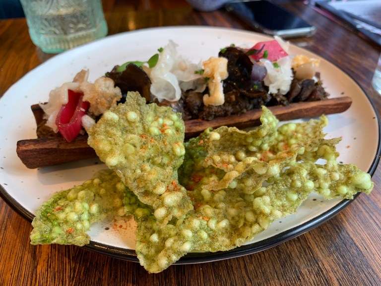 WILD FUNGI SERVED IN THE WOOD IT WAS GROWN ROASTED AND TOPPED WITH MUSHROOM CRISPS & PICKLED SHALLOTS